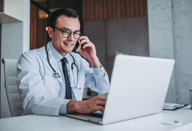 Doctor working on laptop working on health partnerships